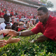 Former Georgia running back and Republican candidate for U.S. Senate, Herschel Walker greets fans at halftime of an NCAA college football game between Georgia and UAB, Saturday, Sept. 11, 2021, in Athens, Ga.